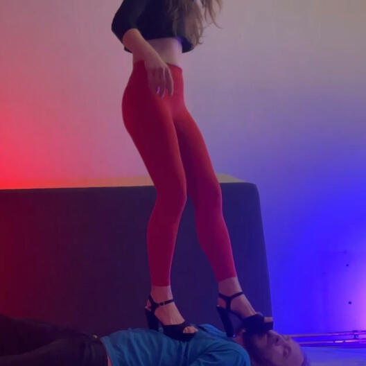 Trampling in pumps and leggings Girl stepping on guy's face in her high-heeled pumps